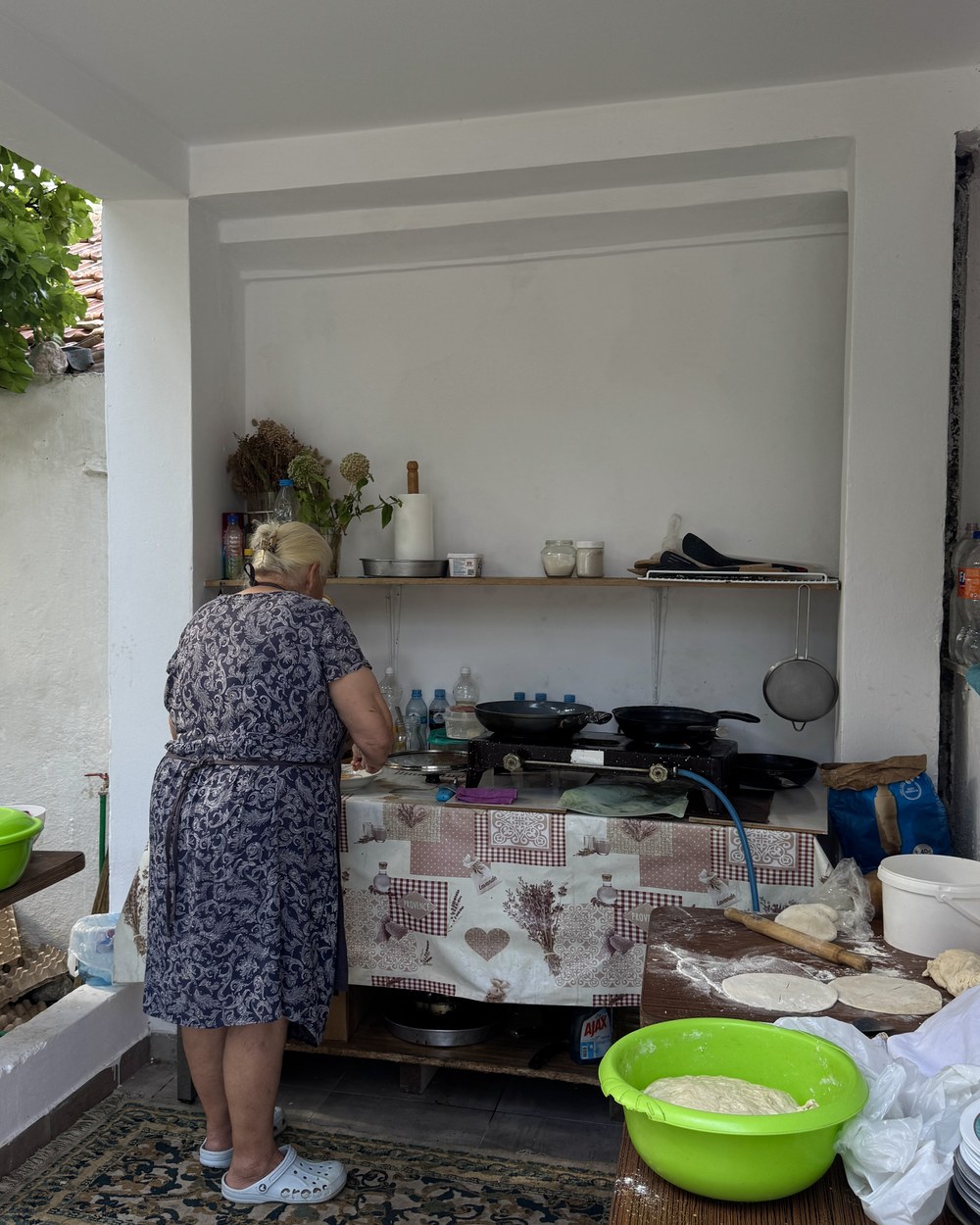 Our homestay host cooking breakfast in her kitchen in the Albanian Alps