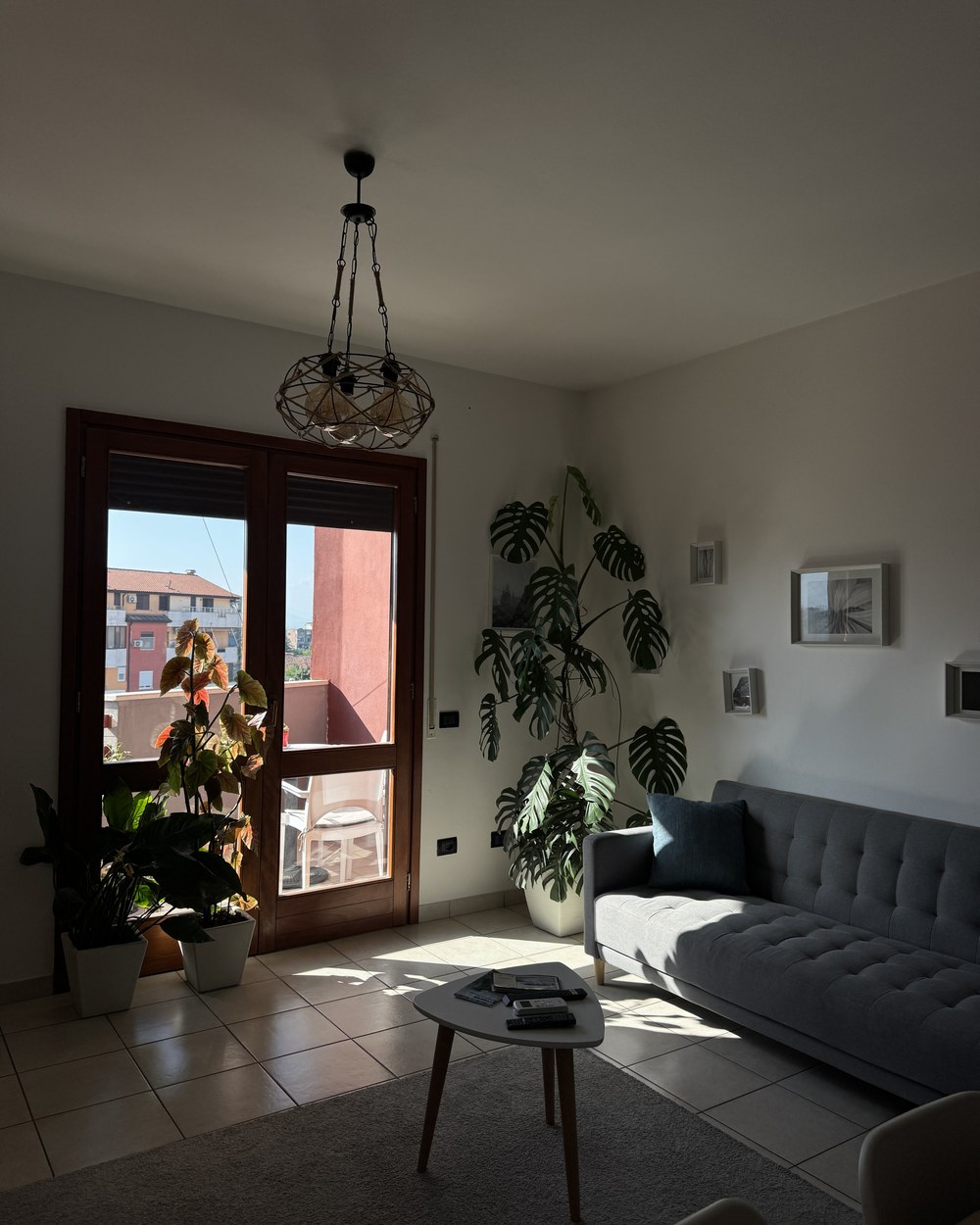 Bright living room with a sofa and balcony doors in our Shkodër apartment, Albania