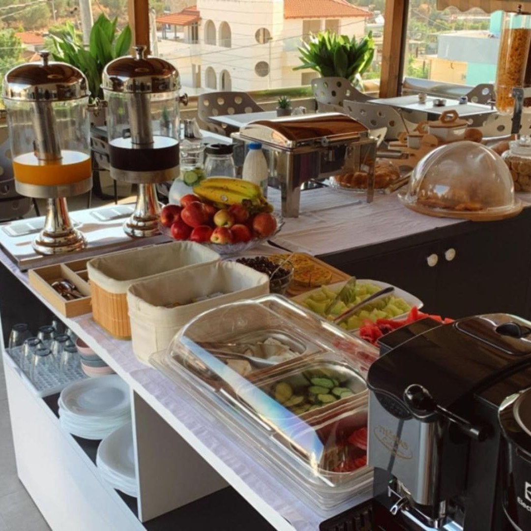 Breakfast buffet laid out on a long table at Vila Llanaj in Ksamil, Albania