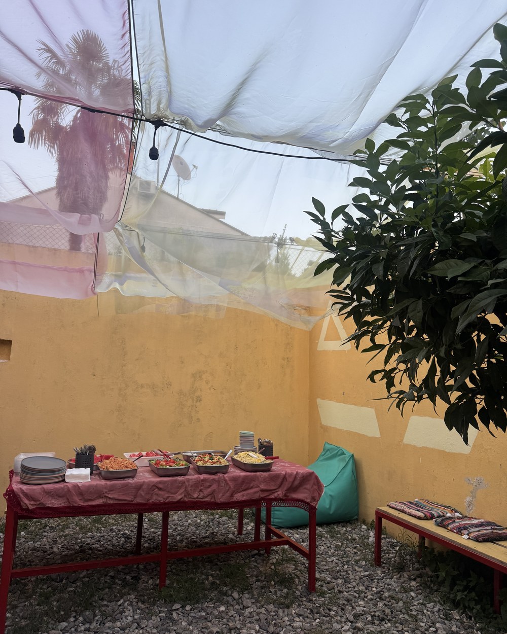Communal dinner laid out on a long table at Tias Hostel in Shkodër, Albania