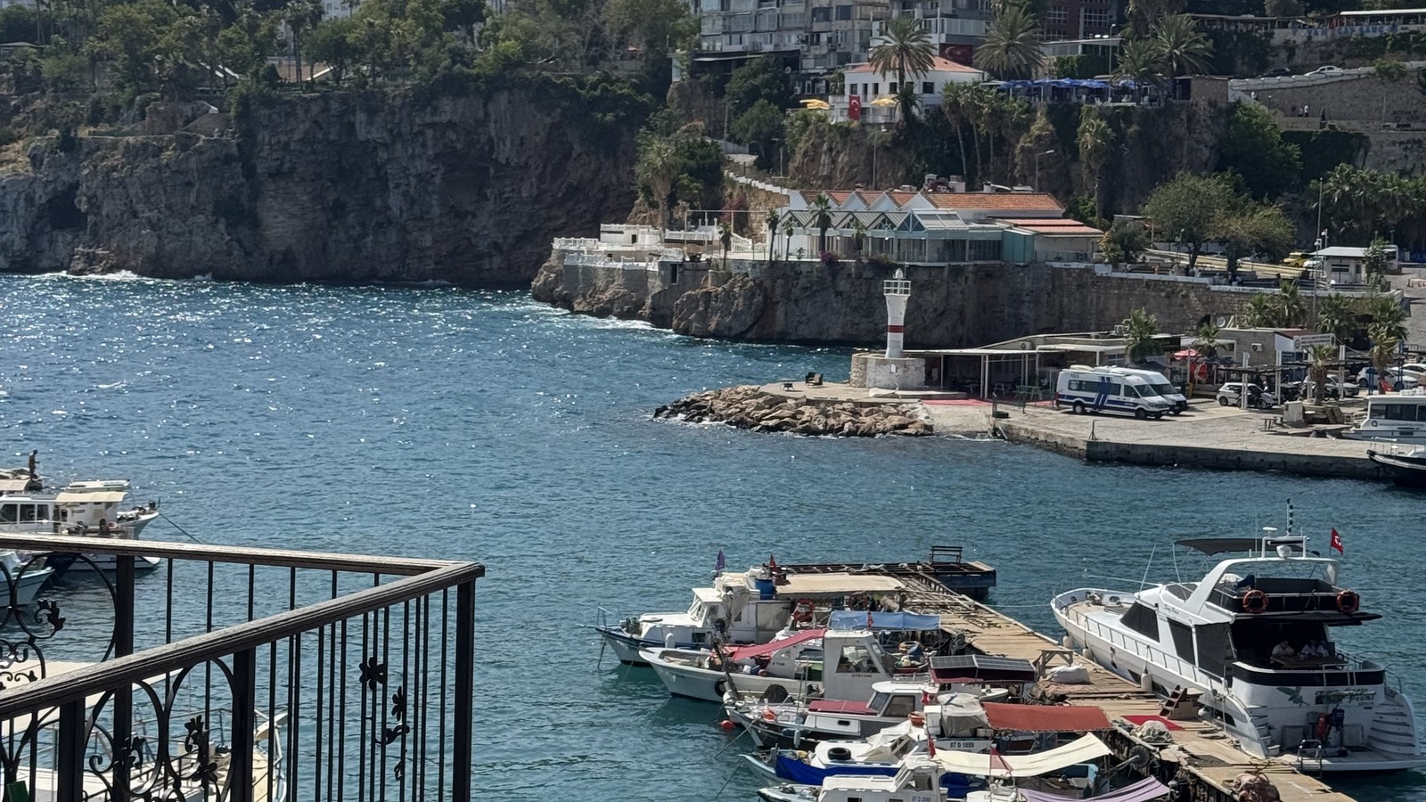 Fishing boats moored in the old harbour at Antalya below the stone walls of the old town