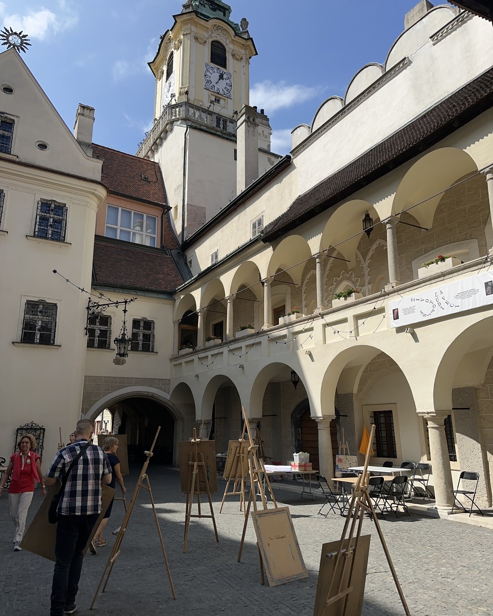 The arcaded main square of Bratislava old town with artists' easels set up outside