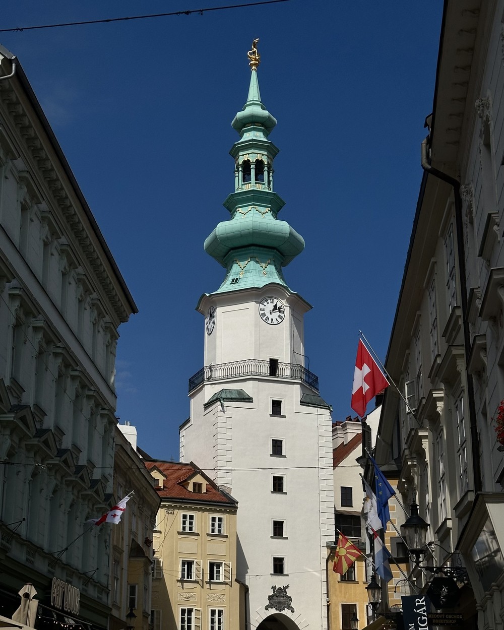 Michael's Gate tower rising above a narrow street in Bratislava old town