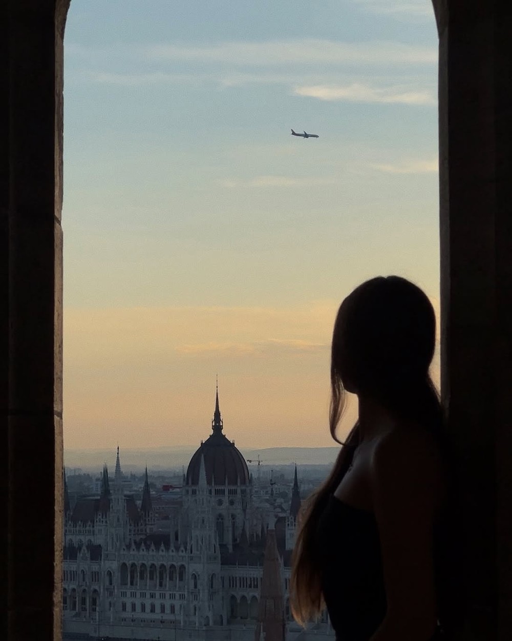 Silhouette against the sunset with the Hungarian Parliament across the Danube from Fisherman's Bastion