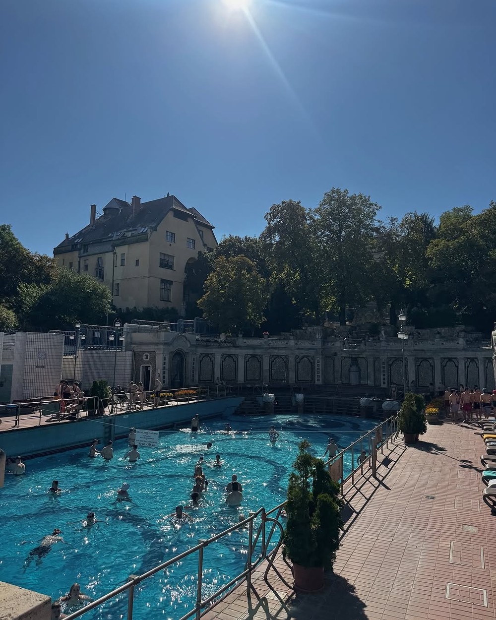 Outdoor thermal pool with bathers and grand architecture in Budapest