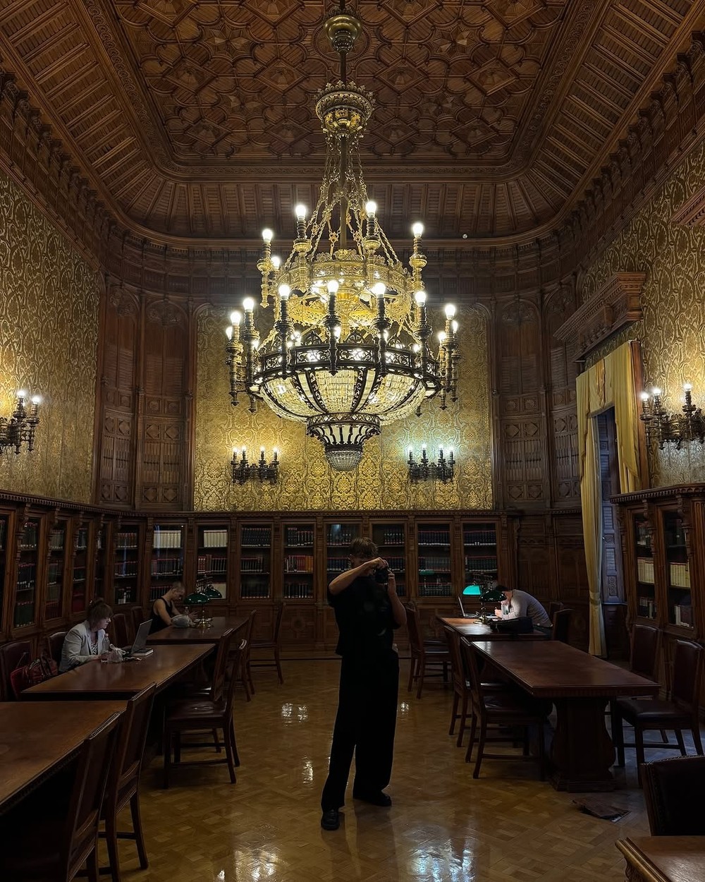 The grand chandeliered reading room of the Metropolitan Ervin Szabo Library in Budapest