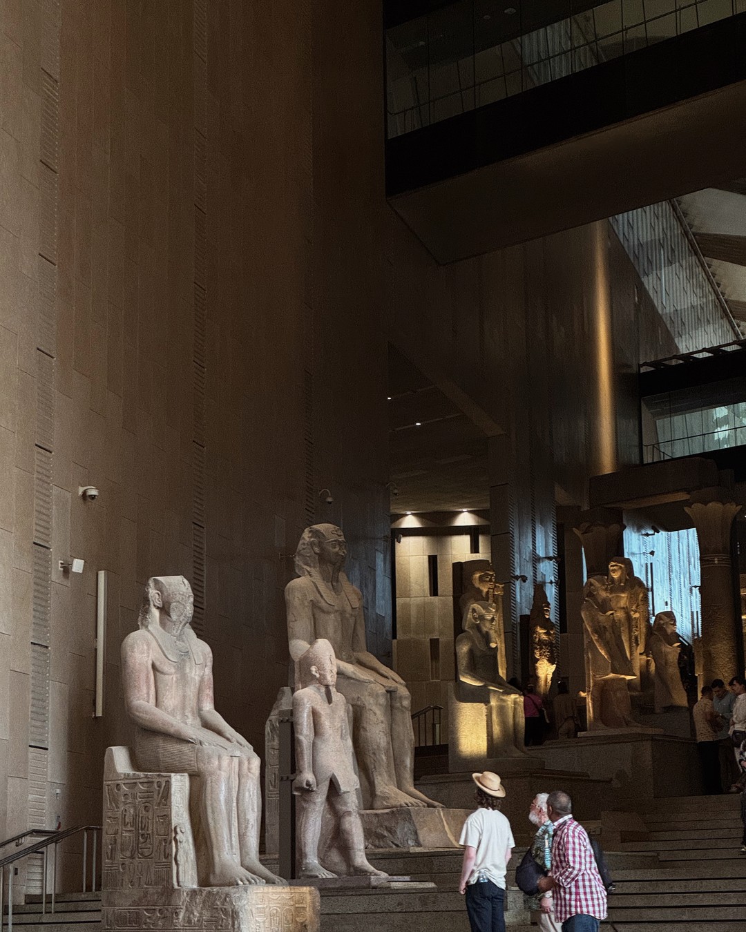 Ancient Egyptian statues inside the Grand Egyptian Museum in Giza