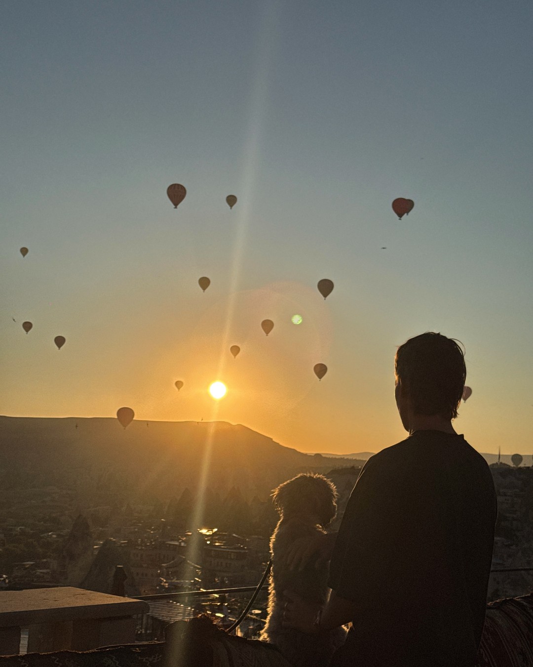 Hot air balloons rising over the valley at sunrise in Cappadocia