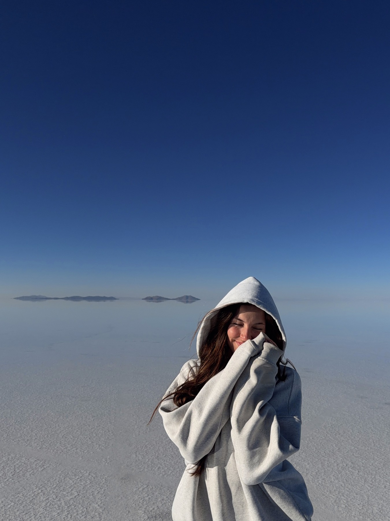 Ellen keeping warm beside the Uyuni salt flats at dawn