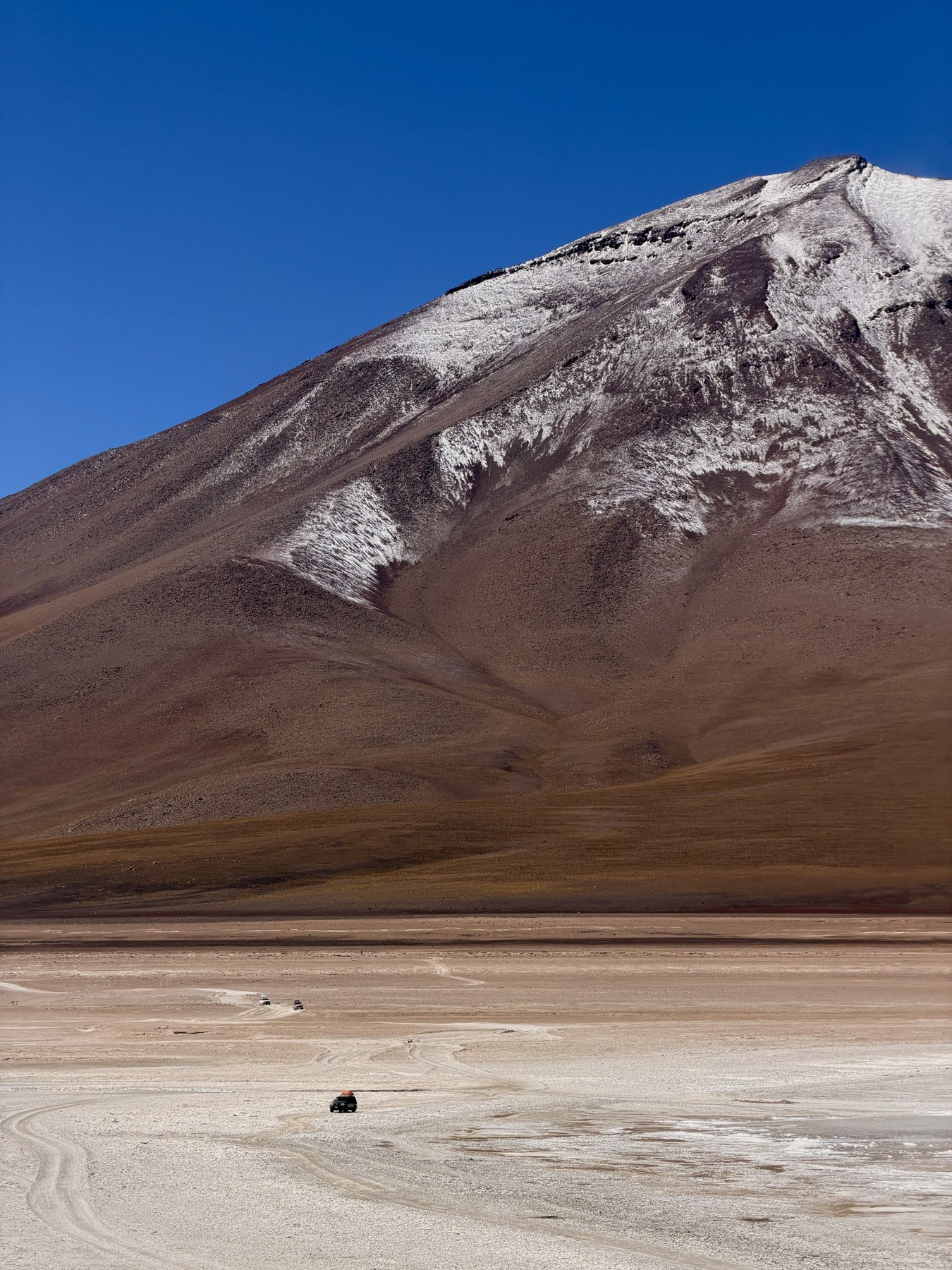 Our four-wheel drive dwarfed by a mountain on the Bolivia crossing