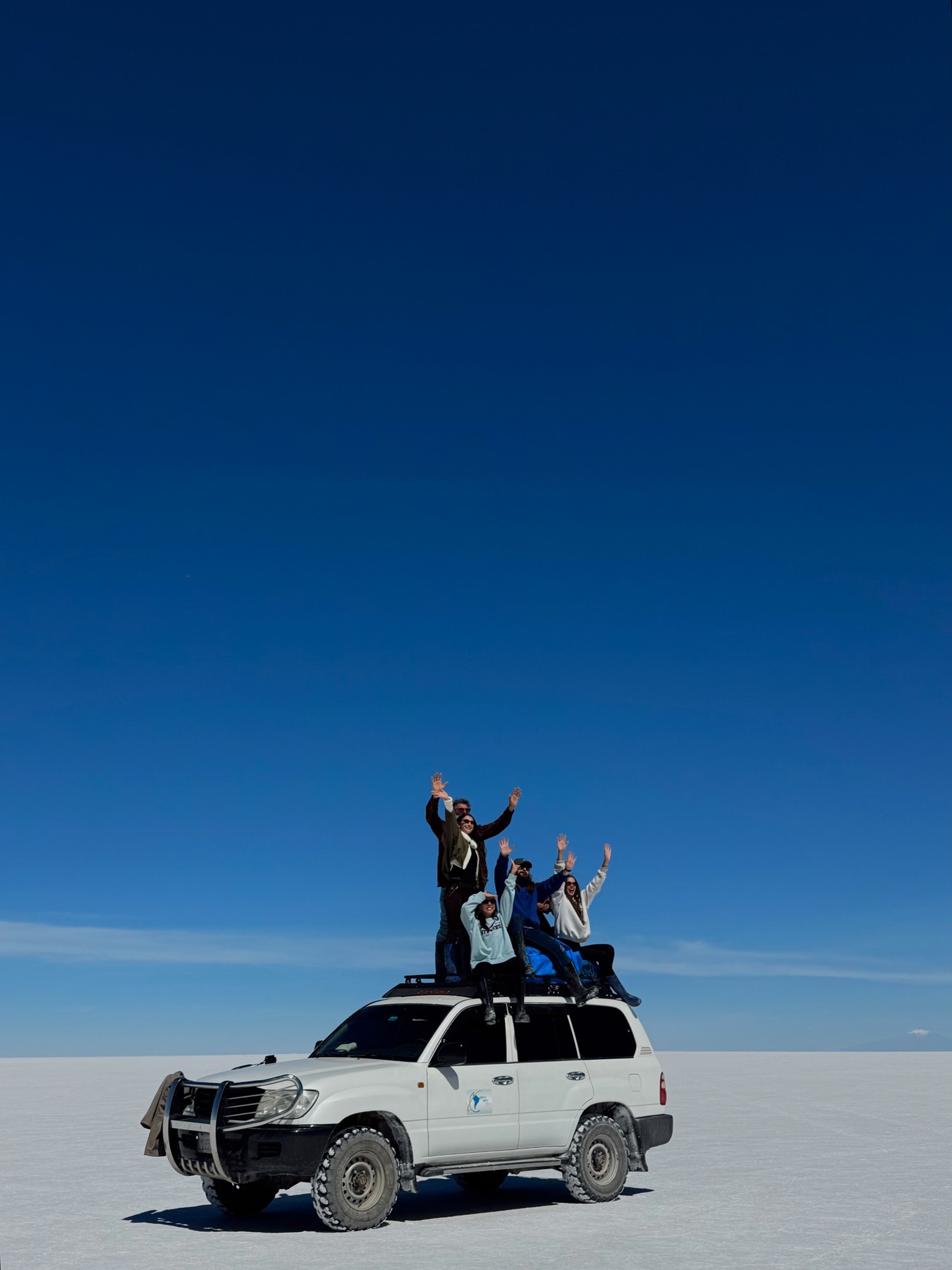 Our group with the four-wheel drive on the dry Uyuni salt flats
