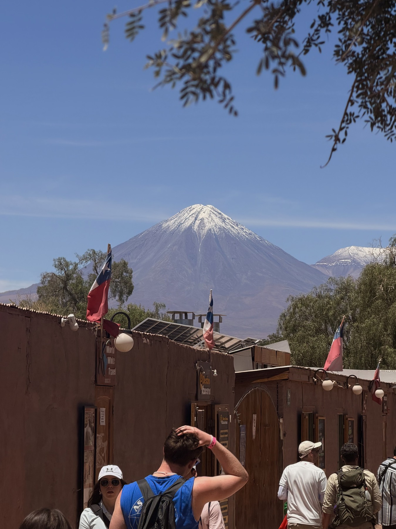 A street in San Pedro de Atacama with a volcano behind the town