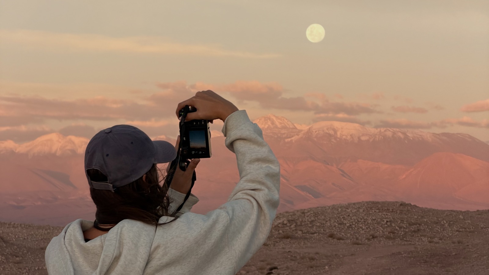 Ellen photographing the moon over the Atacama Desert at sunset