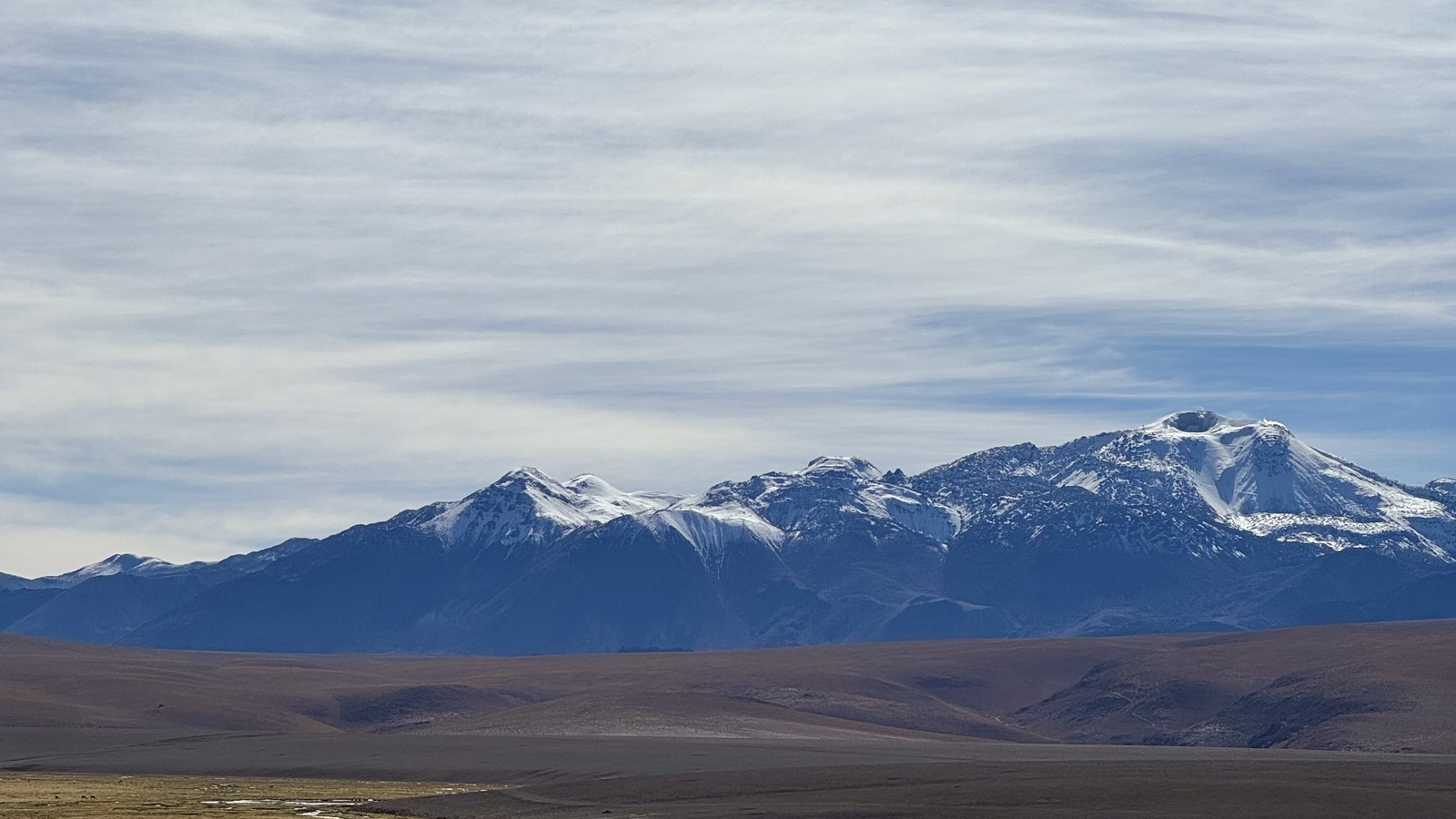 Wetlands and snow-dusted mountains on our El Tatio excursion