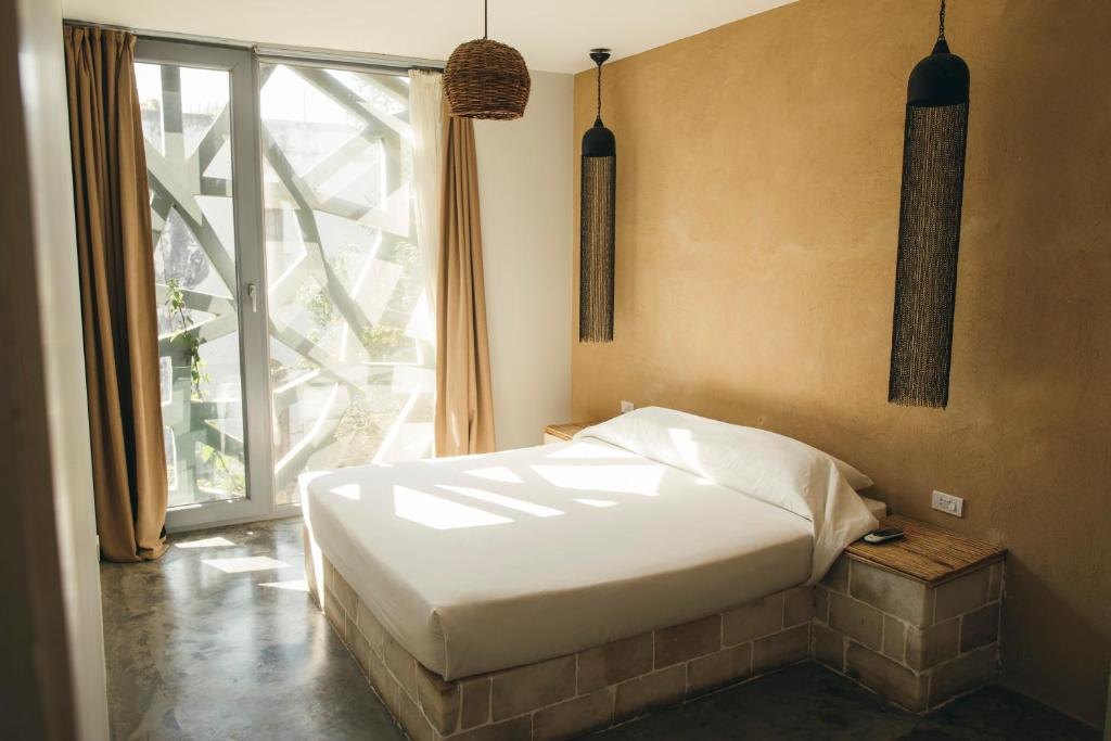 Sunlit minimal bedroom with balcony doors at Dar Dahab