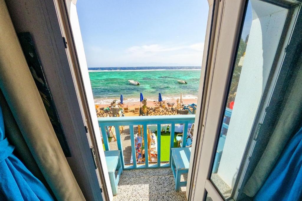 Balcony doors opening onto the Red Sea beachfront at Skyrock Dahab