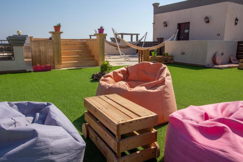 Garden terrace with hammocks and bean bags at Swiss Royal Dahab