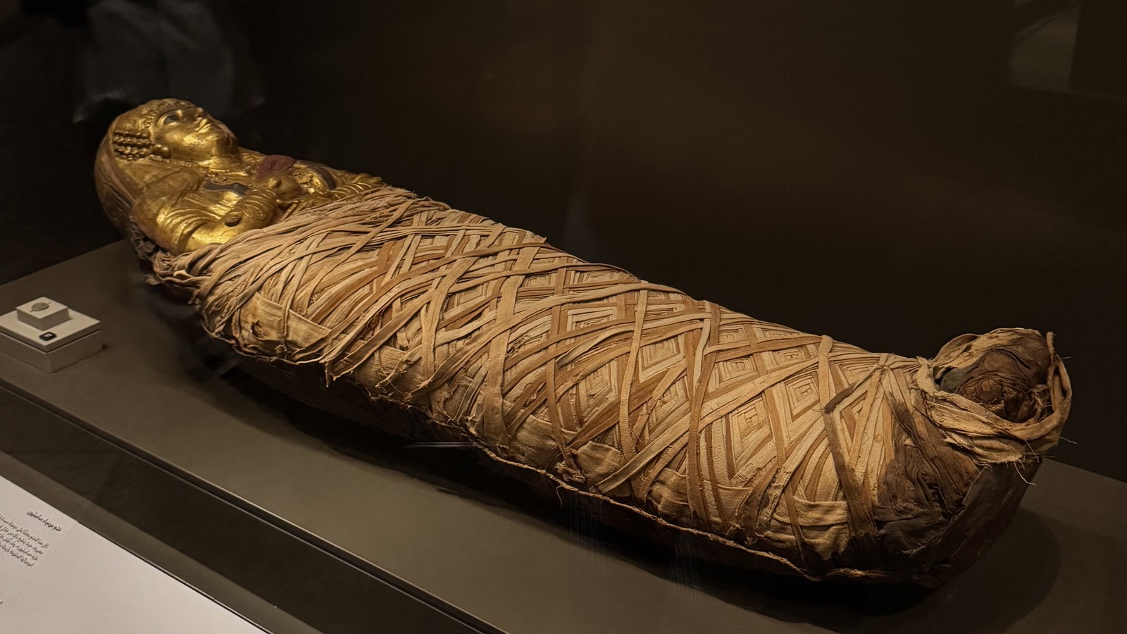 Mummy and ancient papyrus displayed inside the Grand Egyptian Museum in Giza