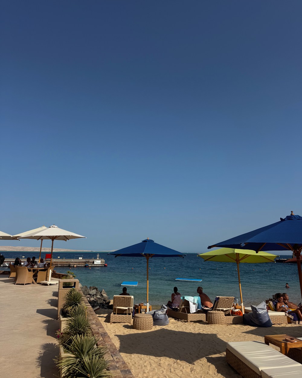 Beach umbrellas and clear Red Sea water at Mahmya Beach Club in Hurghada