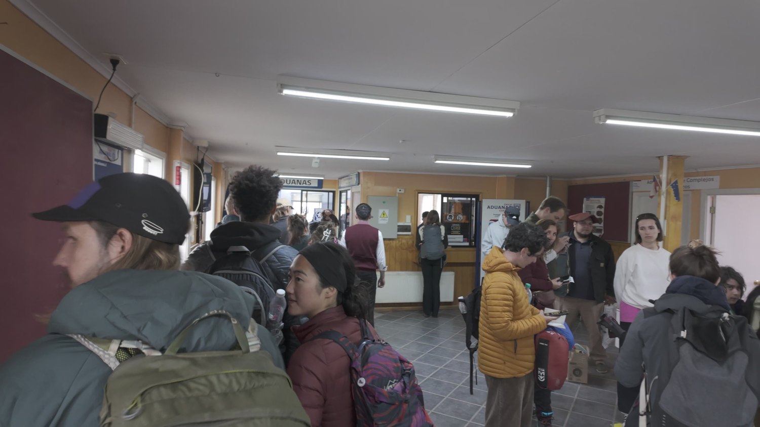 Bus passengers queuing in the customs hall at the Chilean border post