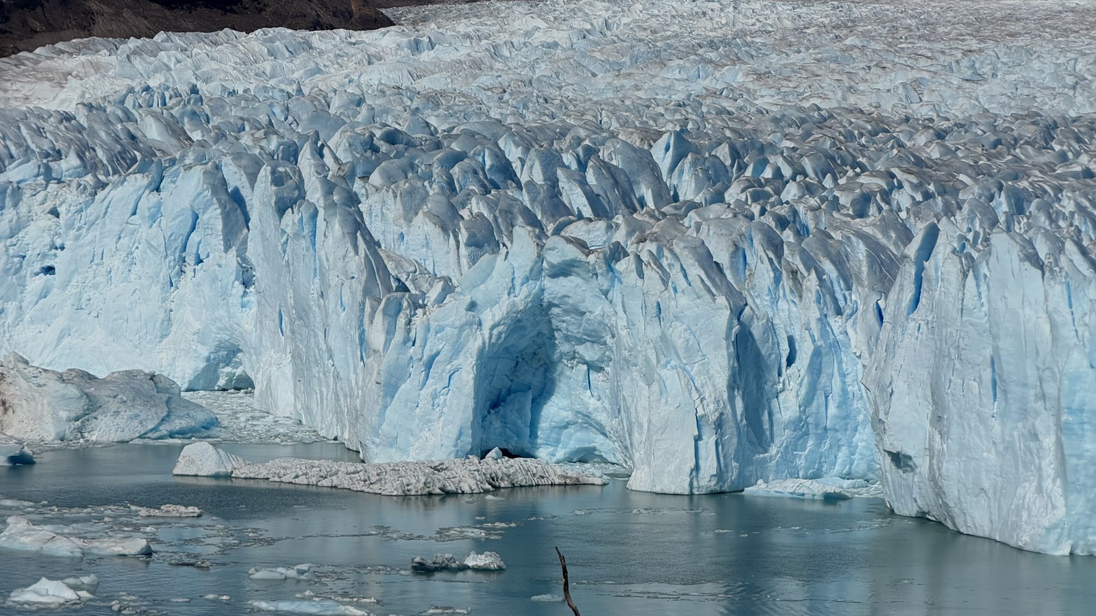 The blue face of Perito Moreno Glacier above the water, from the upper walkway