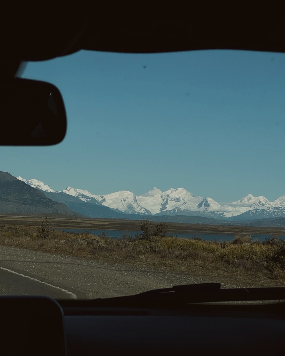 Snow-covered peaks through the windscreen of our car on the drive from El Calafate to the glacier