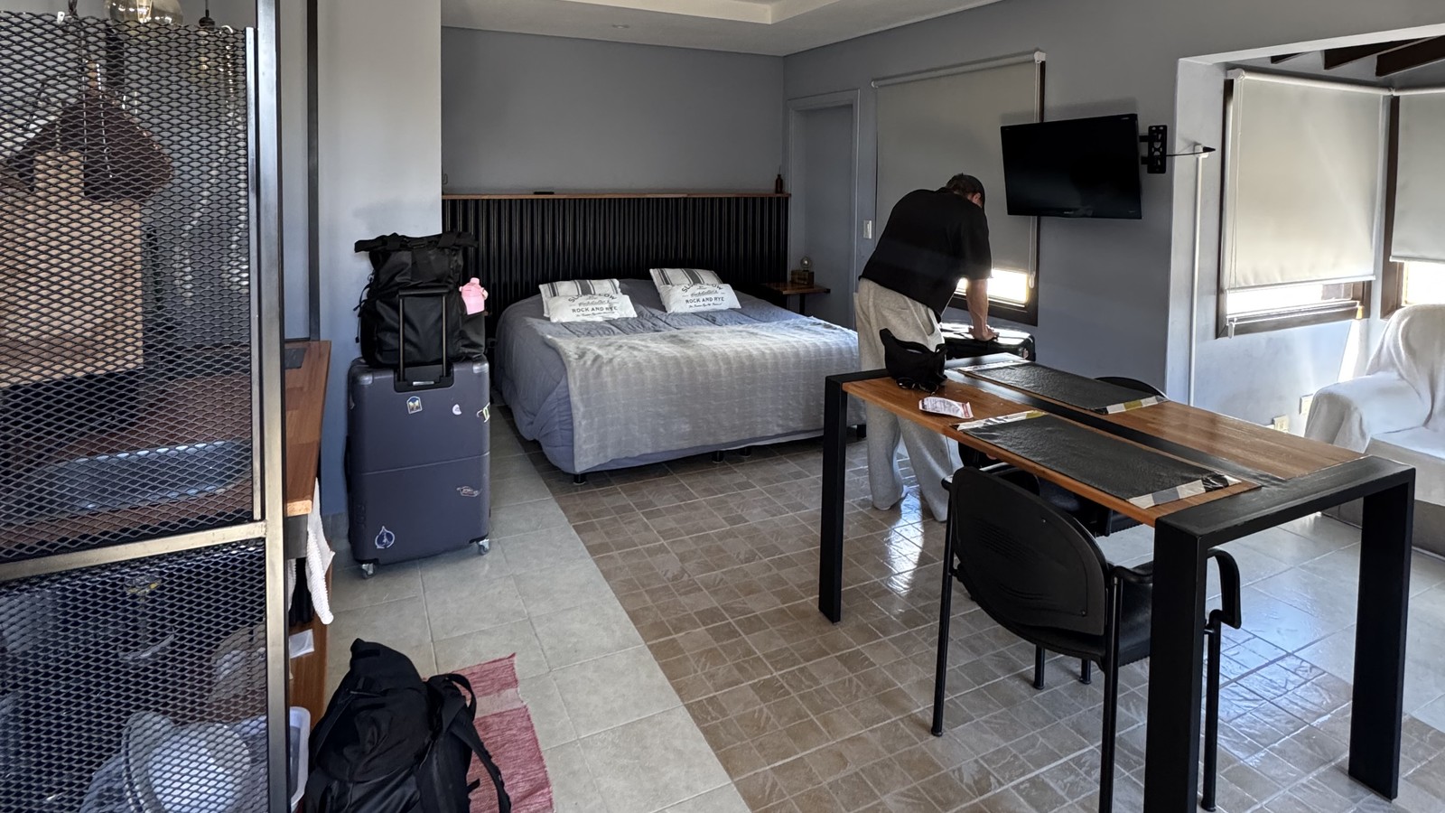 Our second El Calafate Airbnb, a studio with a bed, desk and our bags