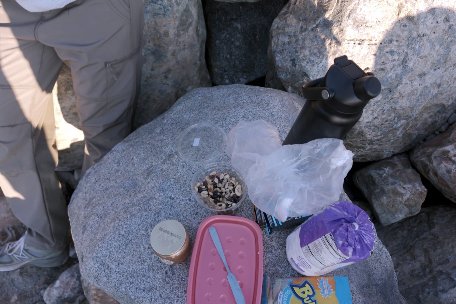 Our hike snacks and water bottle on a rock at the top