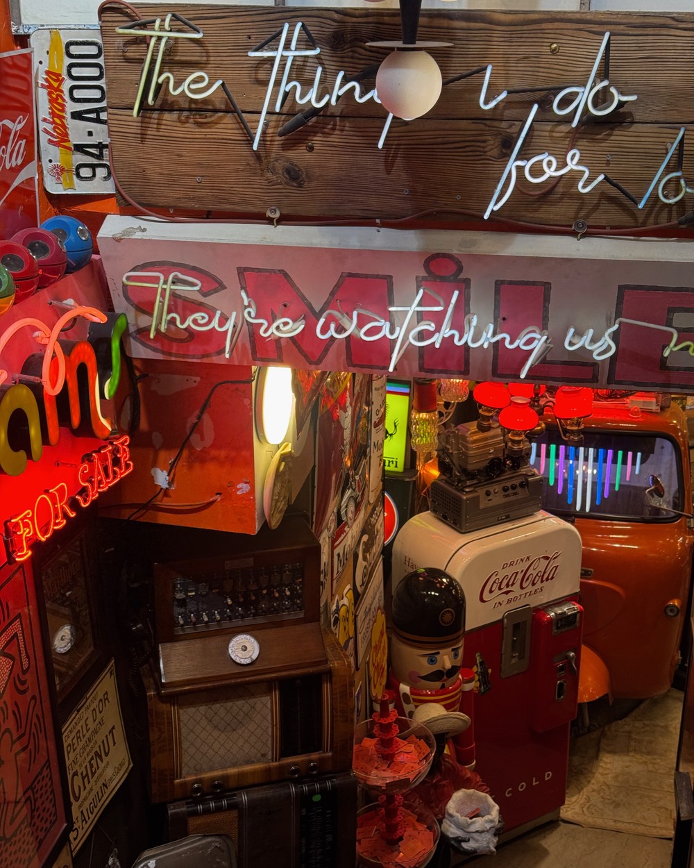 Interior of a vintage shop in Istanbul with neon signs and a vintage Coca-Cola machine