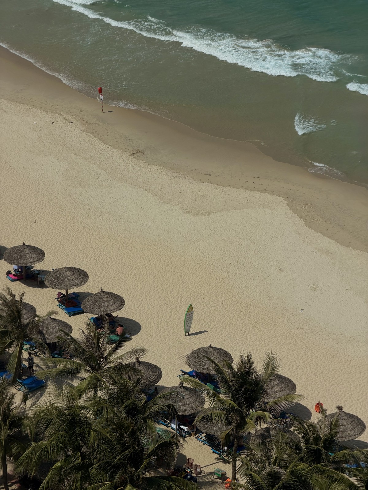 Waves, sand and beach umbrellas along the Da Nang coastline
