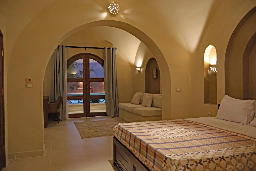 Arched guest room overlooking the pool at Malkata House in Luxor