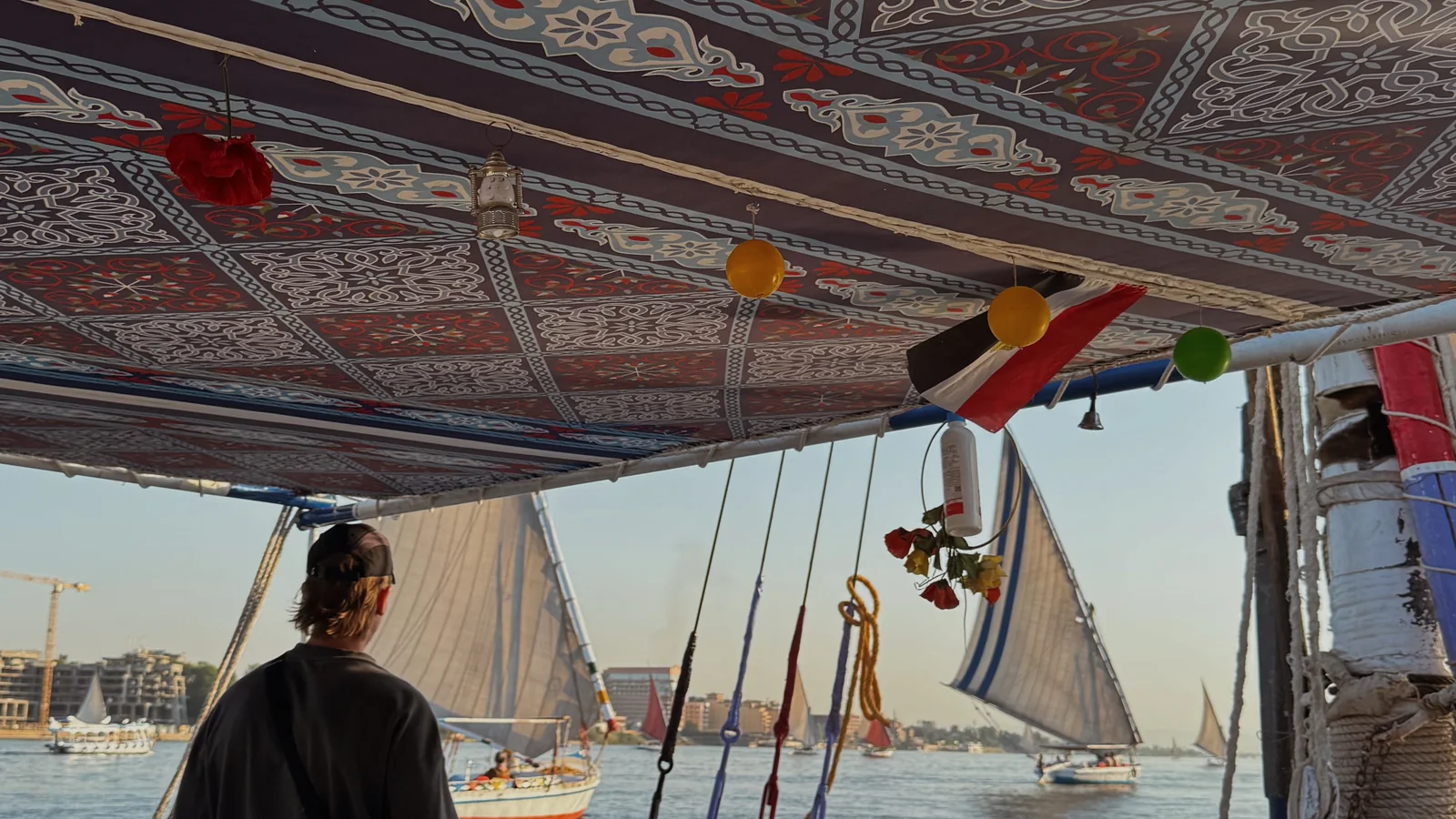 Ellen looking across the Nile from a decorated felucca in Luxor