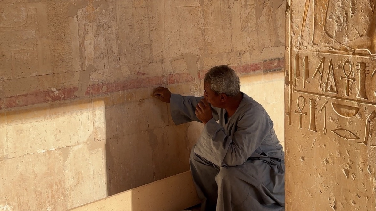 Our Egyptologist explaining original wall carvings inside the Temple of Hatshepsut on Luxor's West Bank