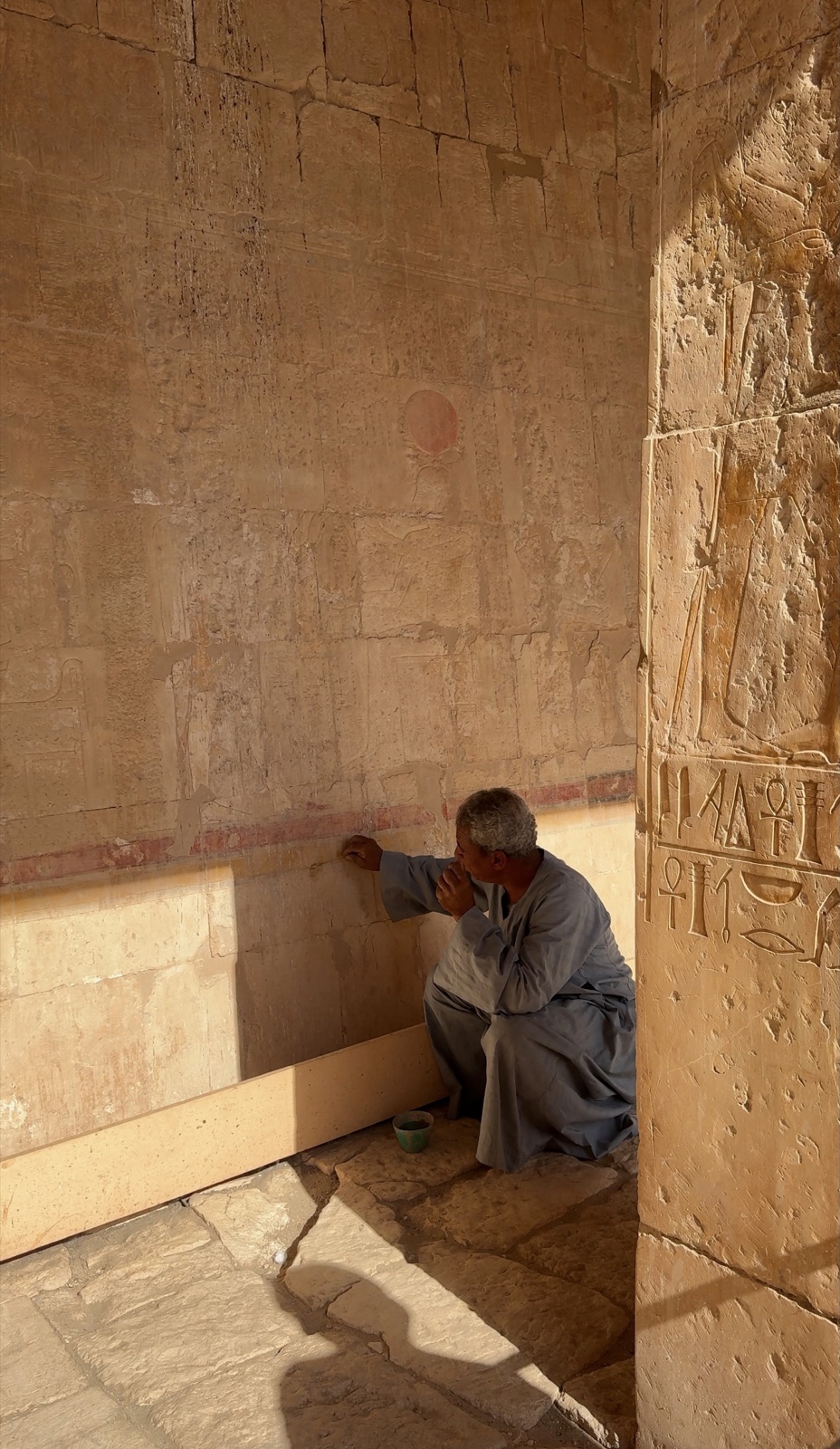Our Egyptologist pointing out original colour and carvings inside the Temple of Hatshepsut in Luxor