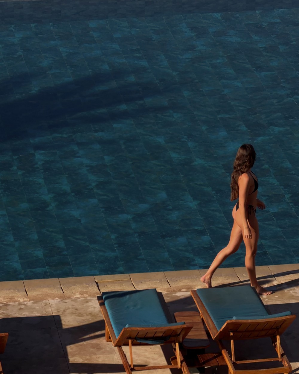 Walking past the pool and loungers at a resort in Taghazout Bay, Morocco