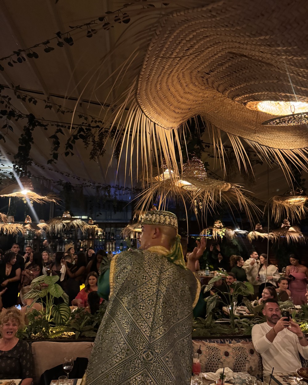 Performer in a gold embroidered costume during the evening show at Safran restaurant in Marrakech, Morocco