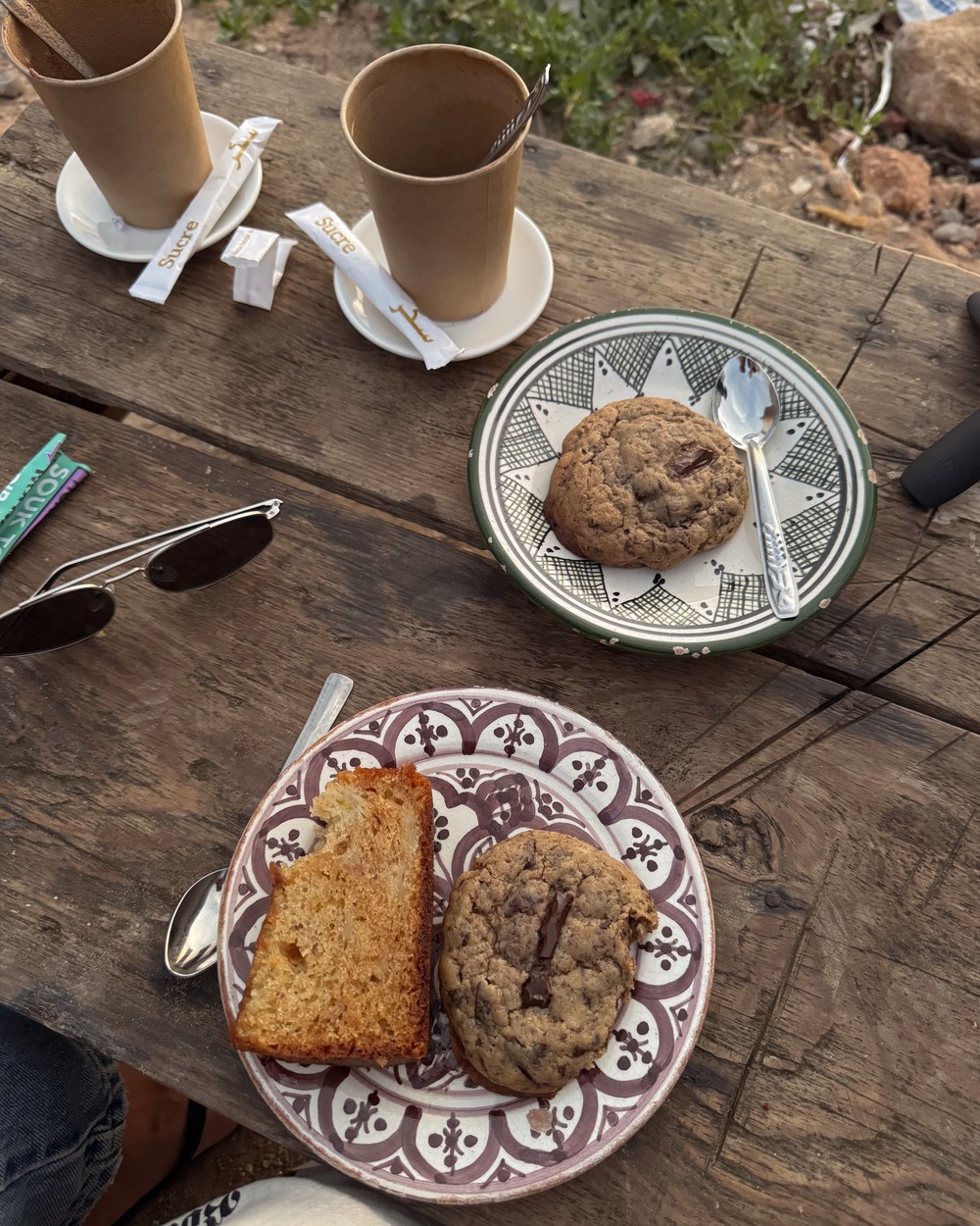 Cookies and coffee served on a patterned plate at a cafe in Tamraght, Morocco