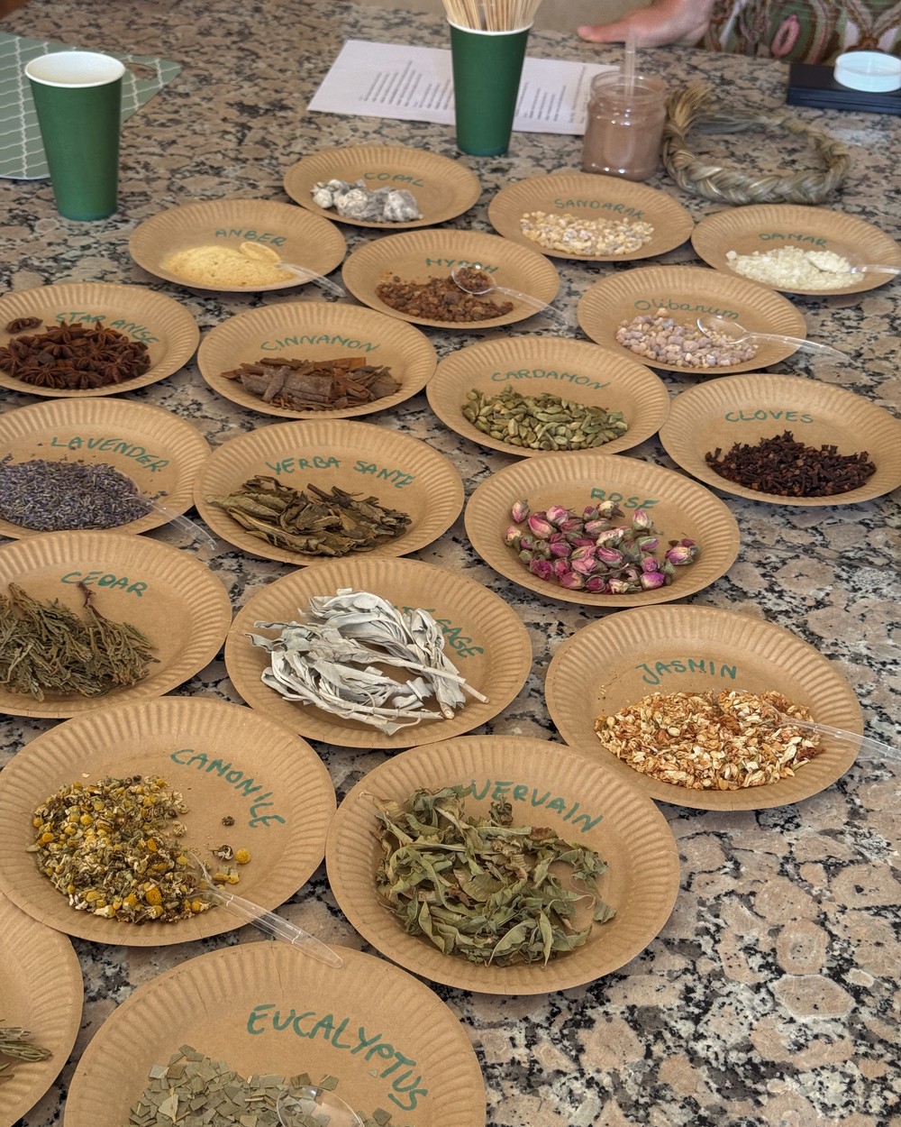 Small plates of herbs, spices and salads laid out on a table in Tamraght, Morocco