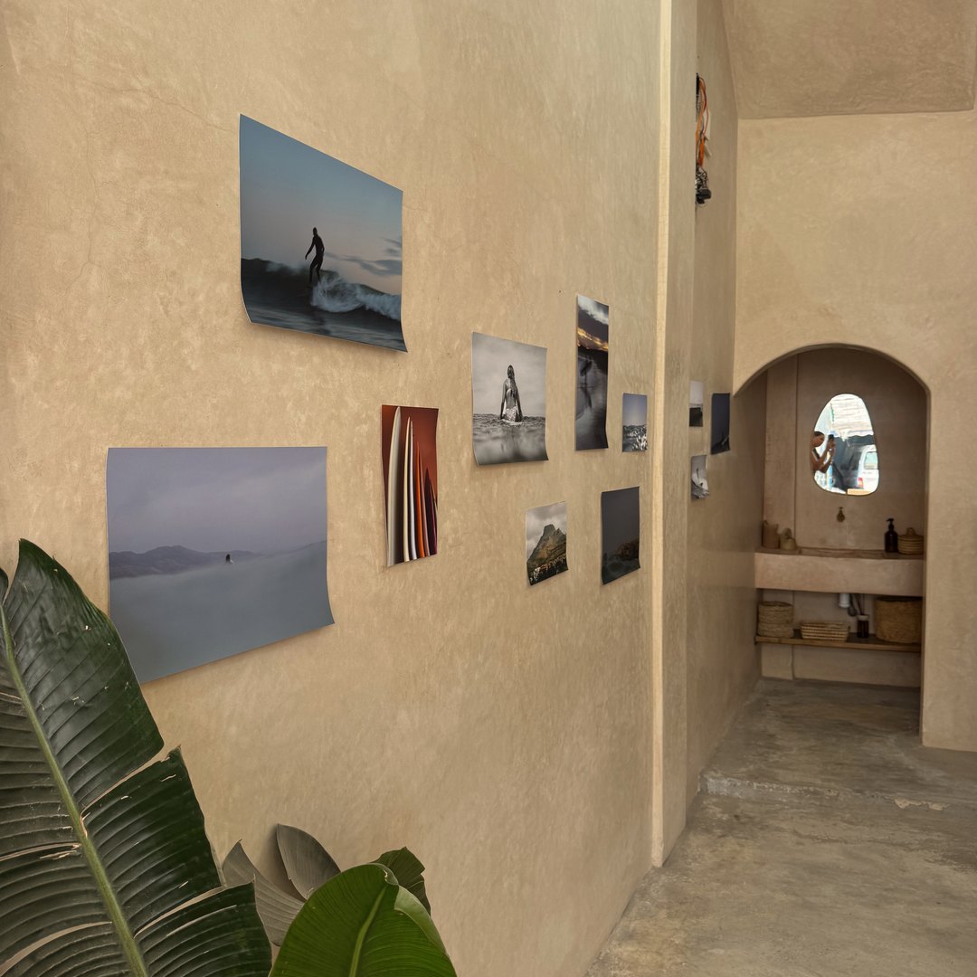 Common room at Blue Surf House in Tamraght with surf photography on the walls, Morocco
