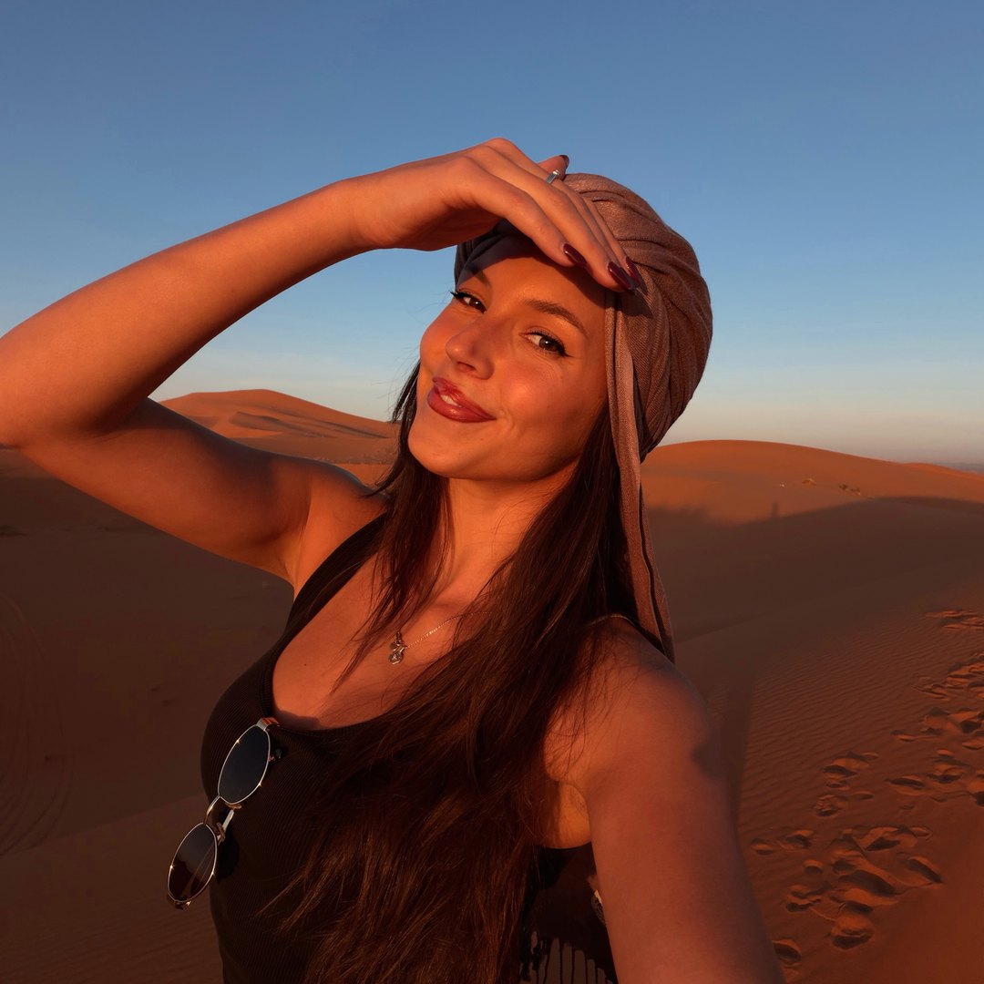 Ellen in a desert scarf on the sand dunes at Merzouga in the Sahara, Morocco
