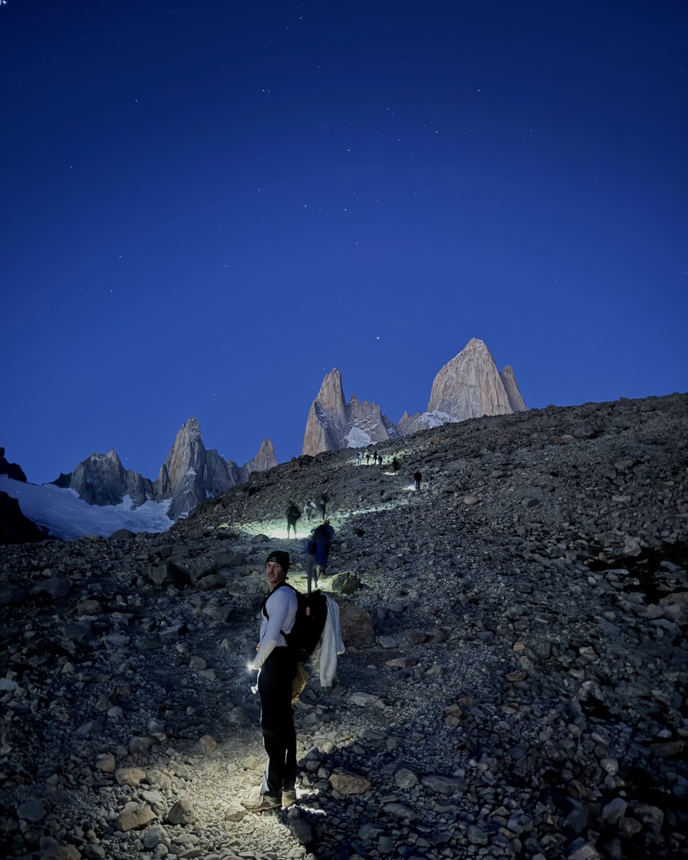 Daniel on the last climb to Laguna de los Tres before dawn, a line of head torches below the Fitz Roy peaks