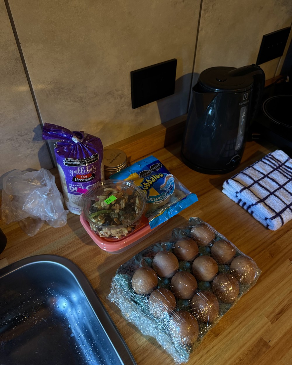 Our hike snacks on the kitchen bench in El Chaltén: rice cakes, a tub of nuts, a bag of lollies and a dozen eggs