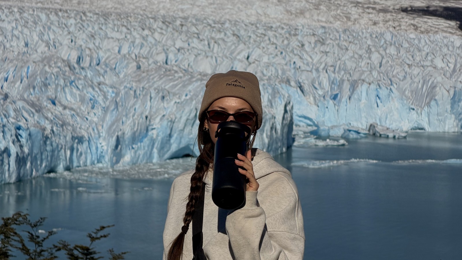 Ellen drinking from her water bottle at the Perito Moreno Glacier railing