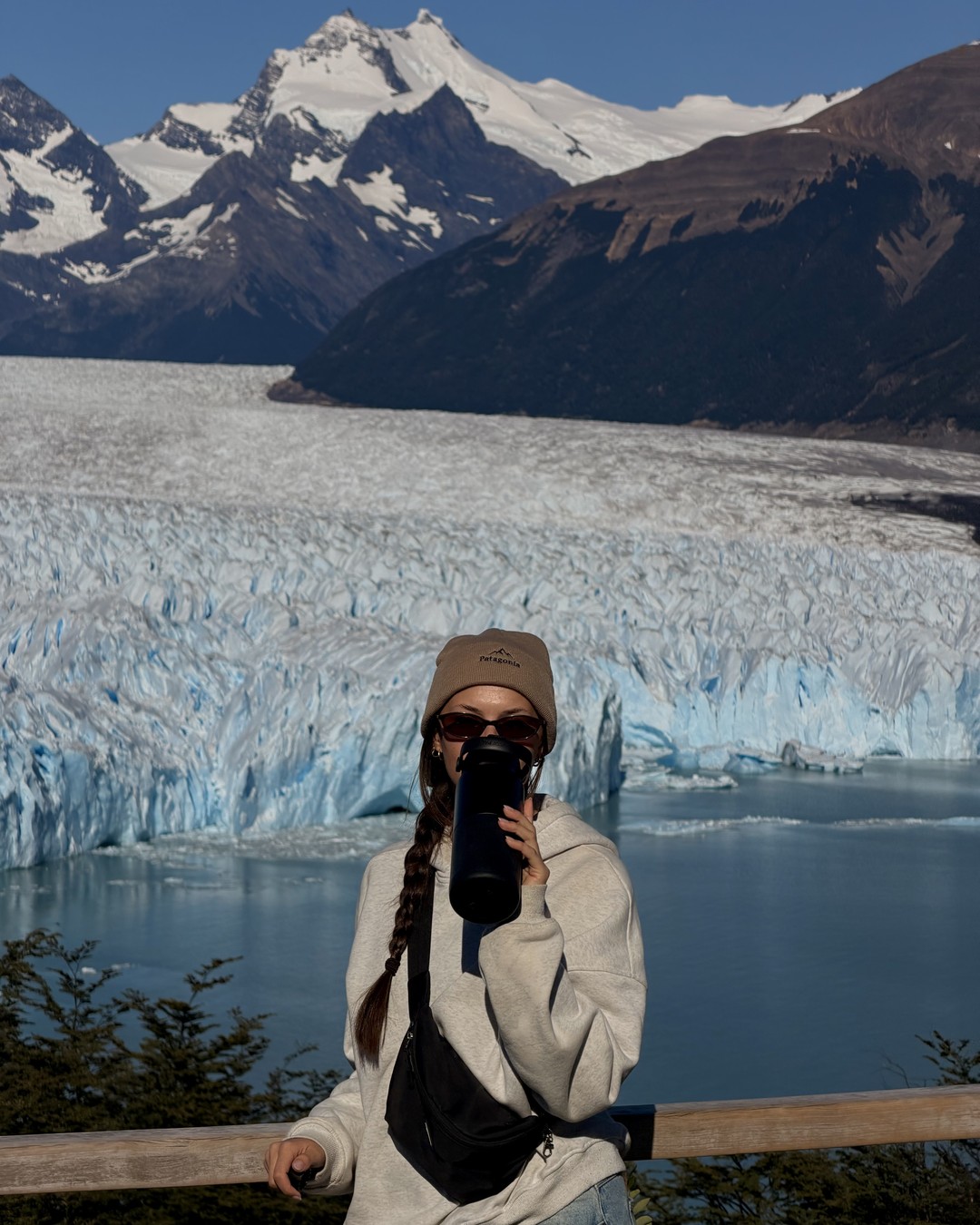 Ellen drinking from her water bottle at the Perito Moreno Glacier railing