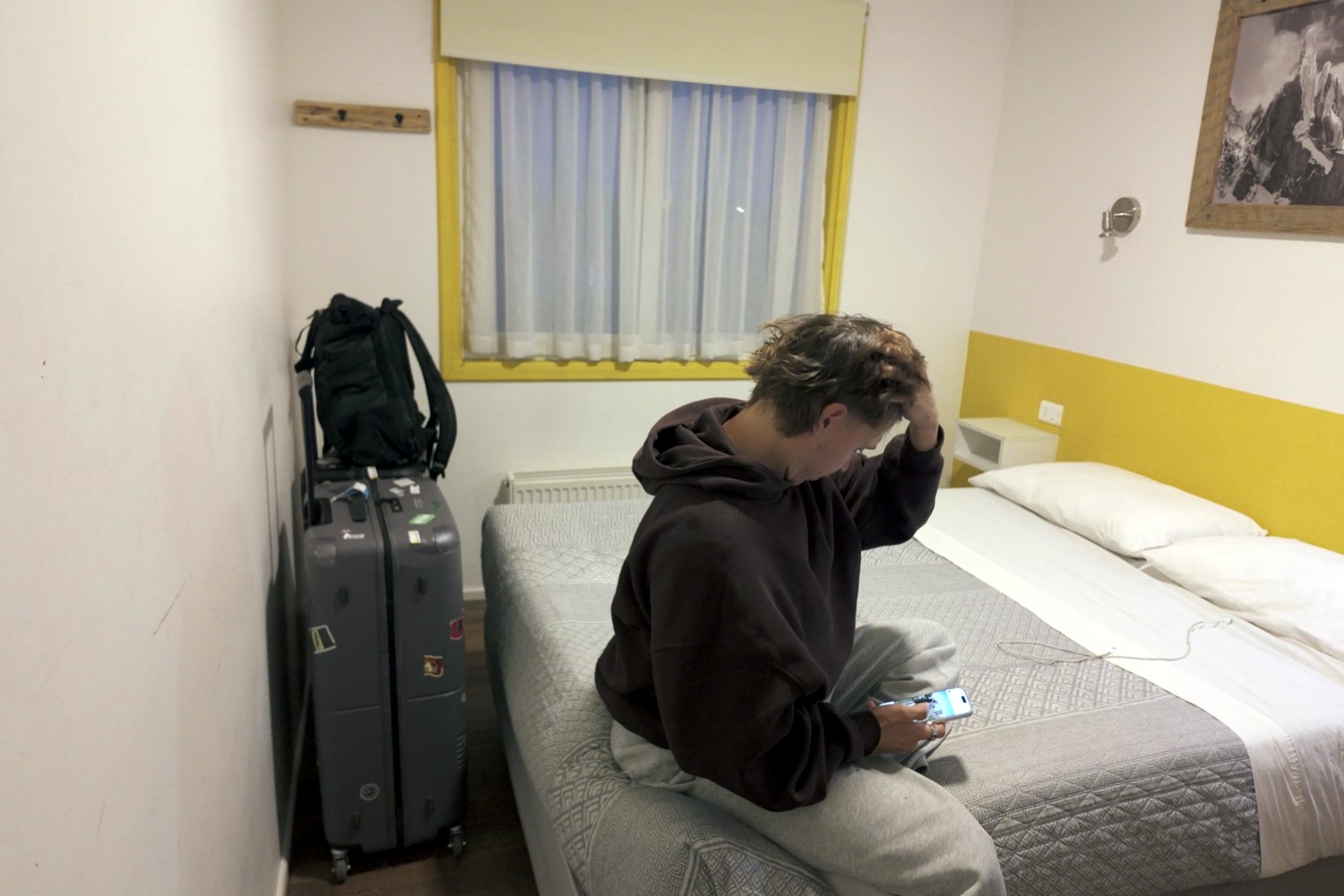 Sitting on the bed in our private room at El Patagónico Hostel in Puerto Natales after the border bus