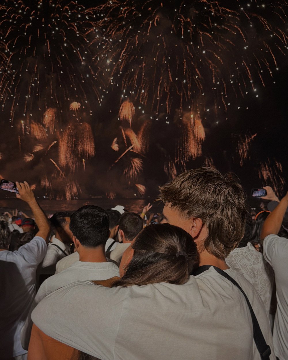 Daniel and Ellen hugging under the New Year's Eve fireworks in Rio de Janeiro