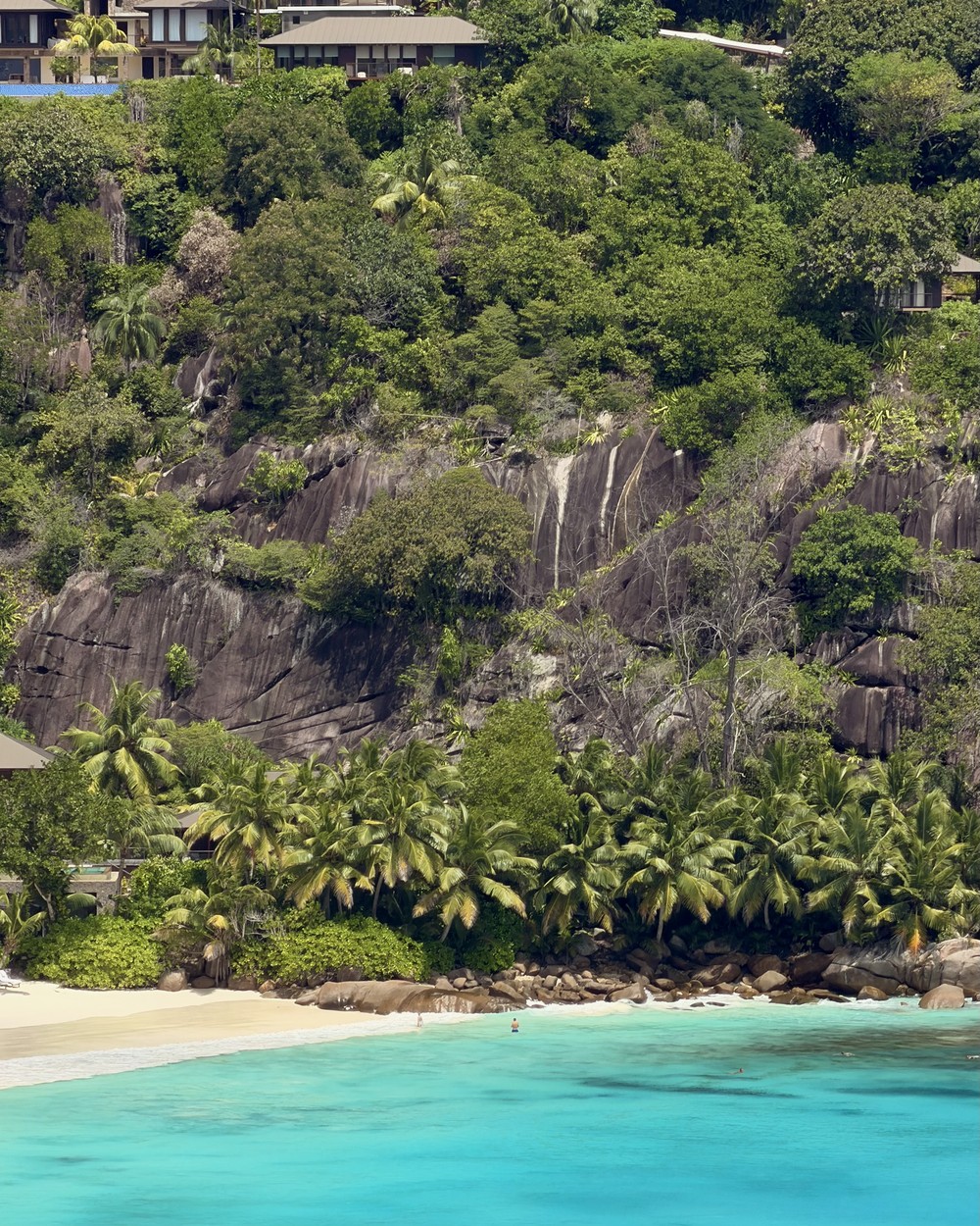 White sand and turquoise water at Petite Anse below the Four Seasons on Mahe