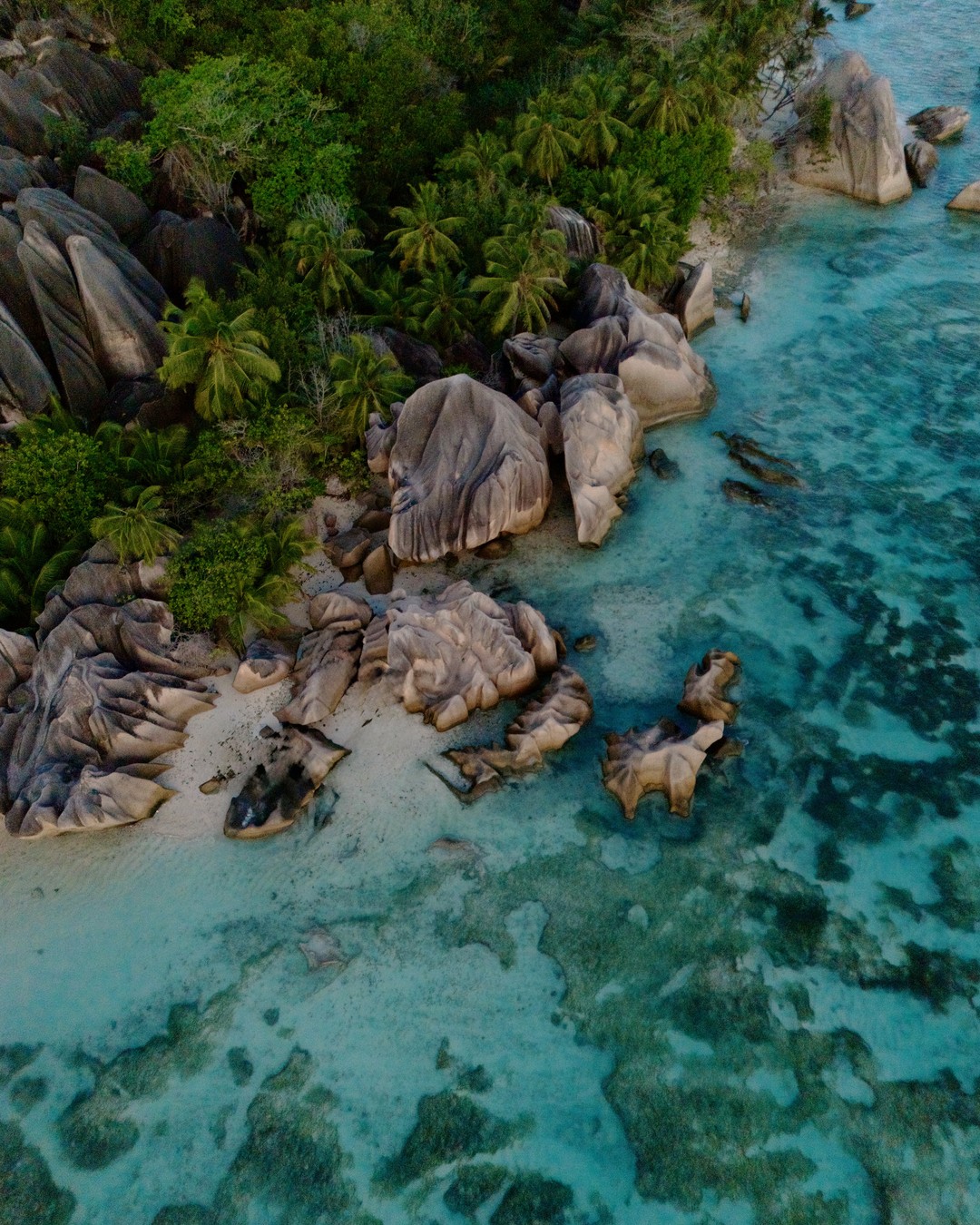 Aerial view of granite boulders and turquoise shallows at Anse Source d'Argent on La Digue
