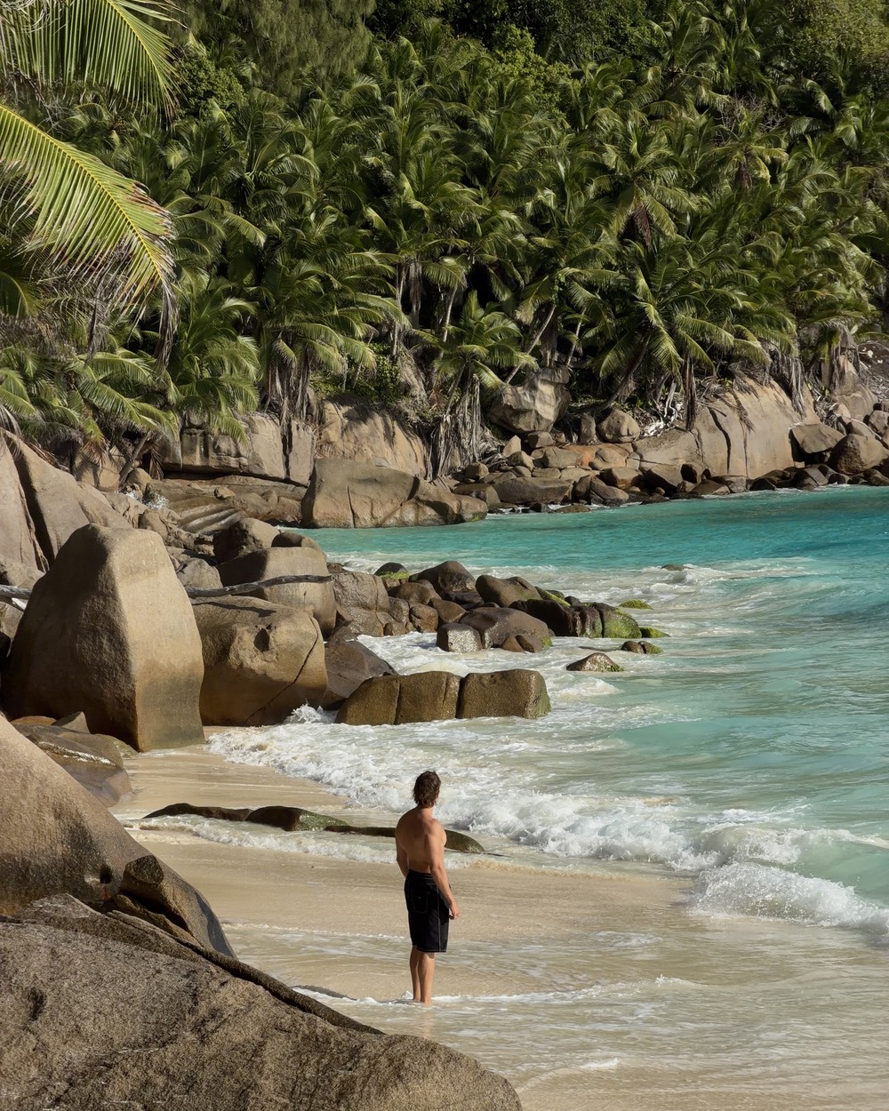 Wild waves and the broad sandy shoreline at Anse Intendance on Mahe in August