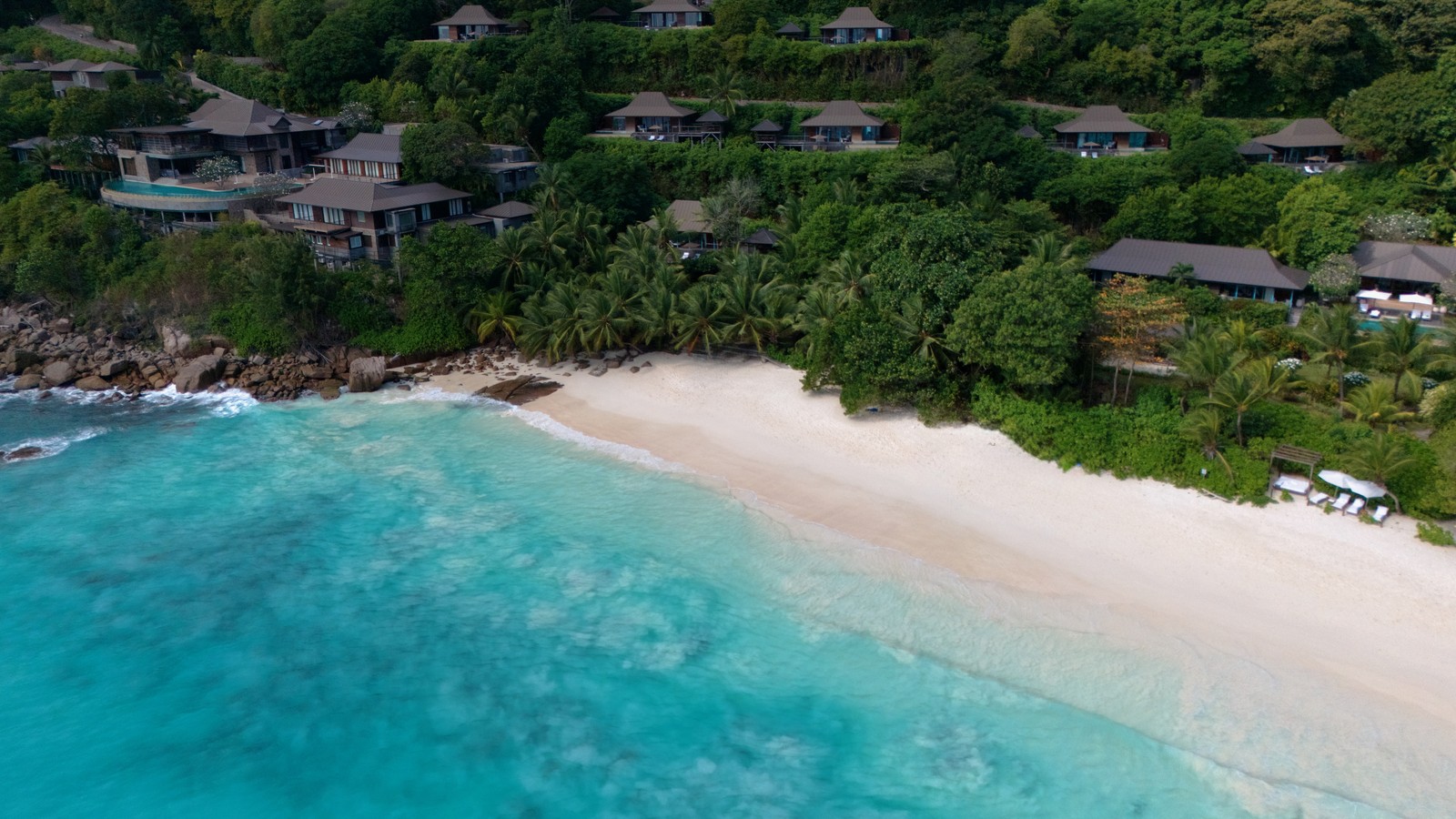 Aerial view of hillside villas above Petite Anse beach on Mahe in Seychelles